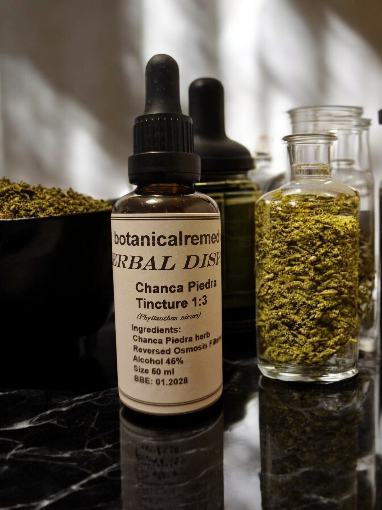 A bottle of Chanca Piedra Tincture with a dropper, an herbal remedy. The label on the bottle reads 'botanicalremedies HERBAL Dispensary' with additional text indicating the product is Chanca Piedra Tincture, with a 1:3 herb to alcohol ratio, 25% alcohol, and it is crafted in the UK.