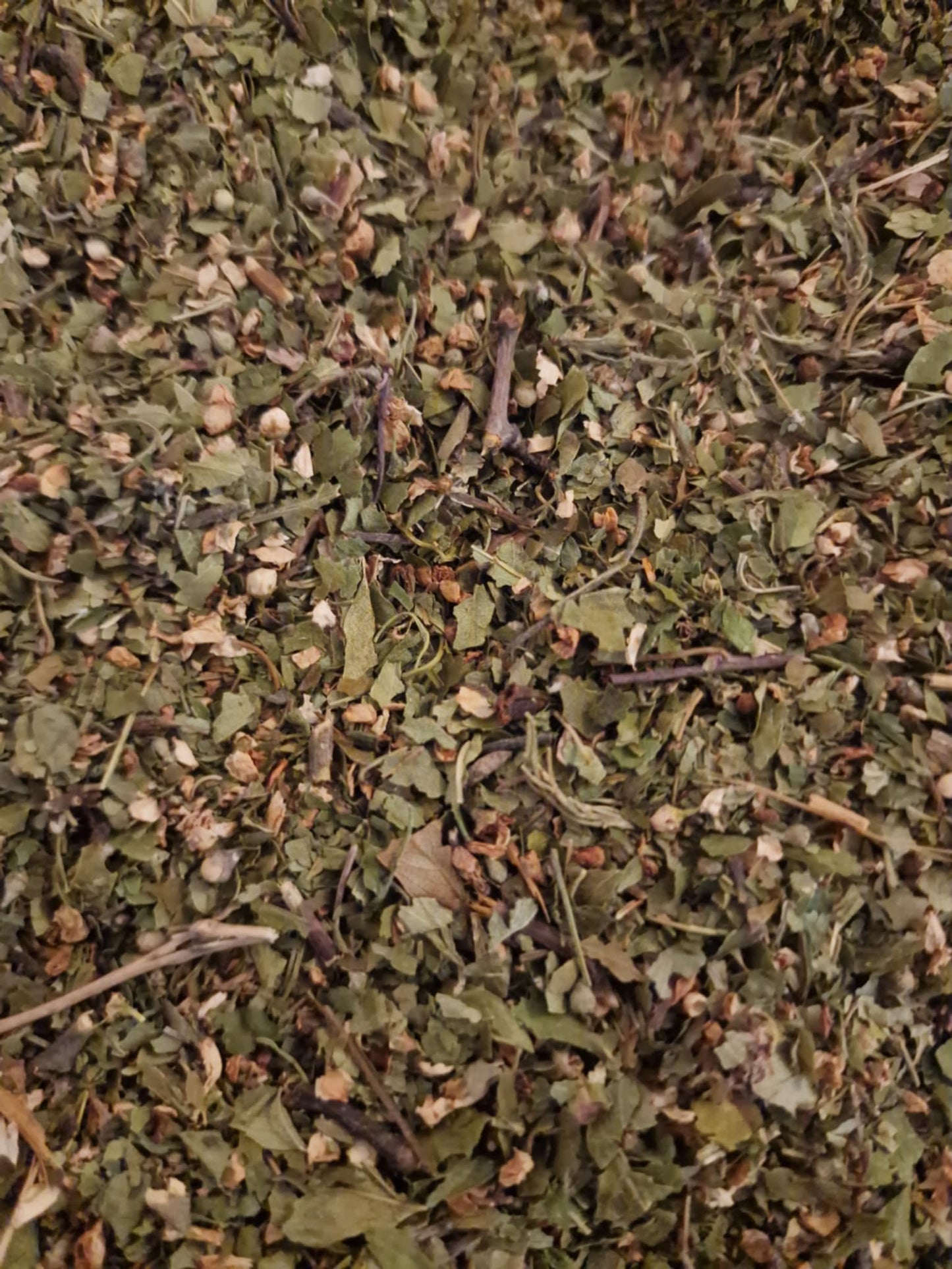 Close-up of dried and cut hawthorn flowering tops, an herbal remedy, loose herbal tea