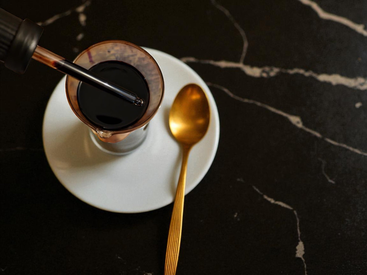 Glass of Chaga liquid with a dropper filed with Chaga tincture from Botanical Remedies herbal dispensary