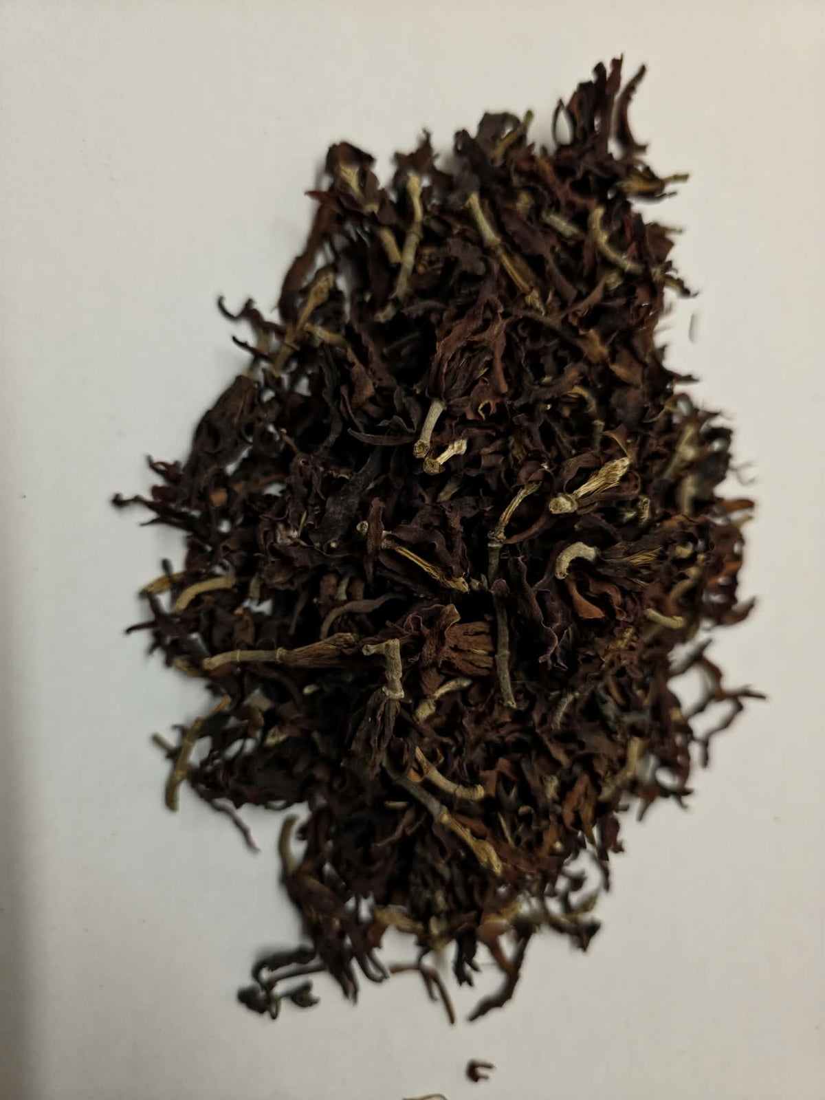 Whole dried Magnolia flowers (Magnolia grandiflora) showing intact dark mahogany blossoms and stems for aromatic tea infusions and nasal steams.
