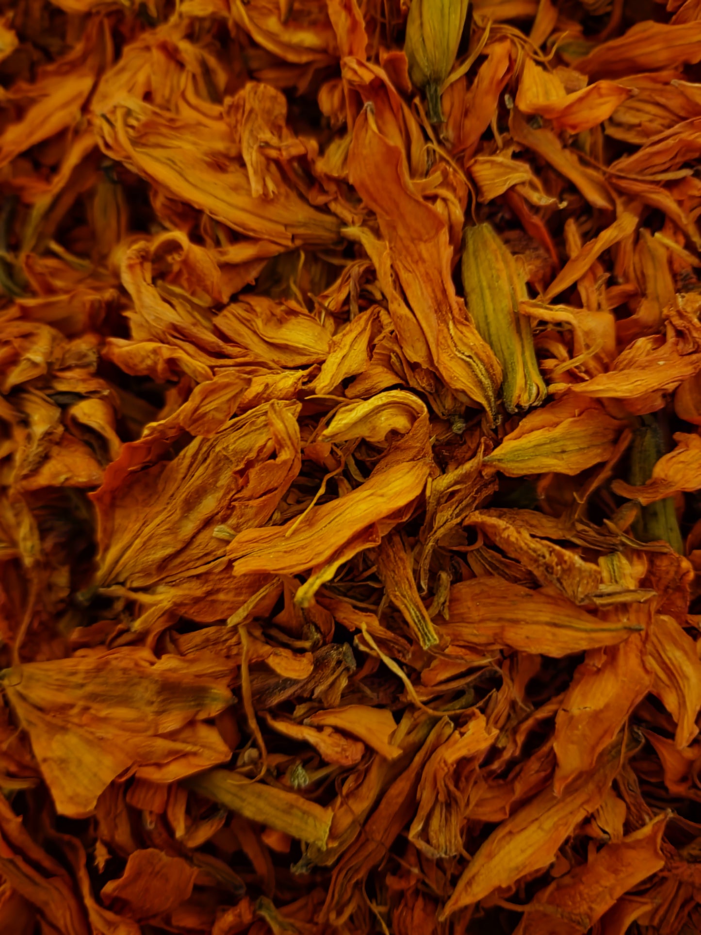 A stunning macro photograph showcasing premium-grade dried Lily flowers (Lilium spp.). The image highlights the vibrant, natural golden-orange and deep amber hues of the delicate petals, demonstrating that this batch is non-irradiated, non-GMO, and free from artificial dyes or sulfur treatments