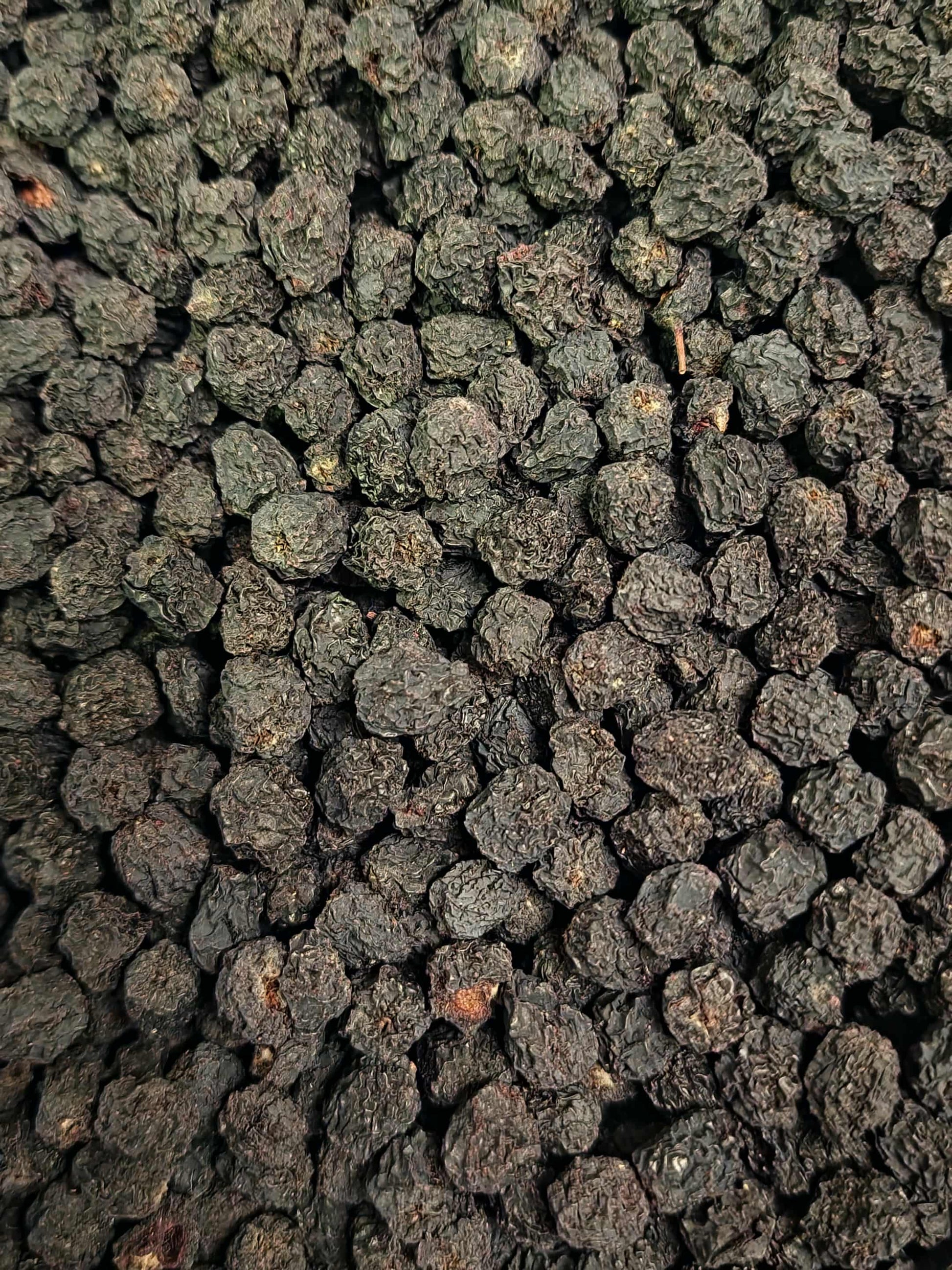 Close-up of dried Black chokeberries, Aronia berries, and herbal remedy from Botanical Remedies, rich in polyphenols and Vitamin C