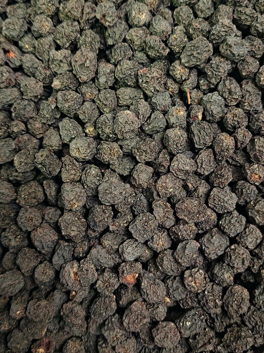 Close-up of dried Black chokeberries, Aronia berries, and herbal remedy from Botanical Remedies, rich in polyphenols and Vitamin C