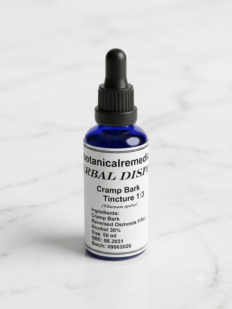 A 50ml cobalt blue glass dropper bottle of practitioner-grade Cramp Bark Tincture 1:3 (Viburnum opulus) by Botanical Remedies, standing upright on a clean, minimalistic white marble background with soft grey veining.