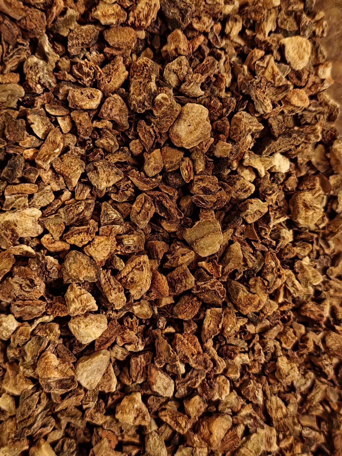 Close-up of dried and cut Devils claw root, an herbal remedy from Botanical remedies herbal dispensary, loose herbal tea