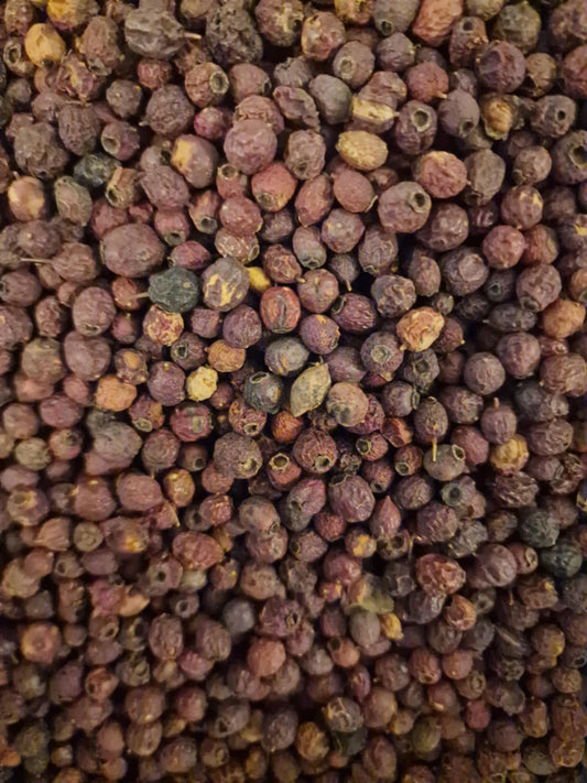 100% pure Soil Association Certified Organic whole Hawthorn berries (Crataegus monogyna) displaying hard deep red and dark brown haws for herbal decoctions.