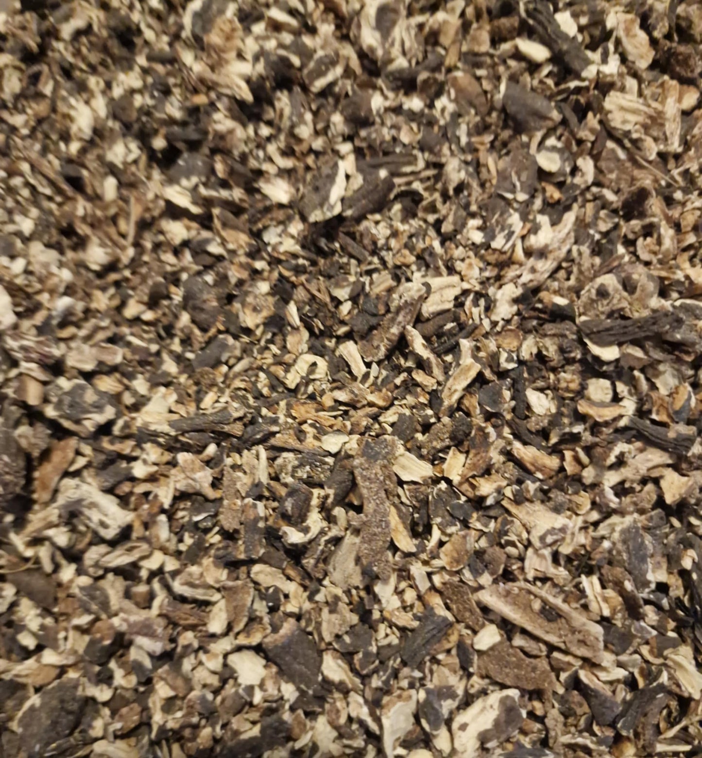 close up of Organic Comfrey root dried and cut, an herbal remedy from botanical Remedies herbal dispensary