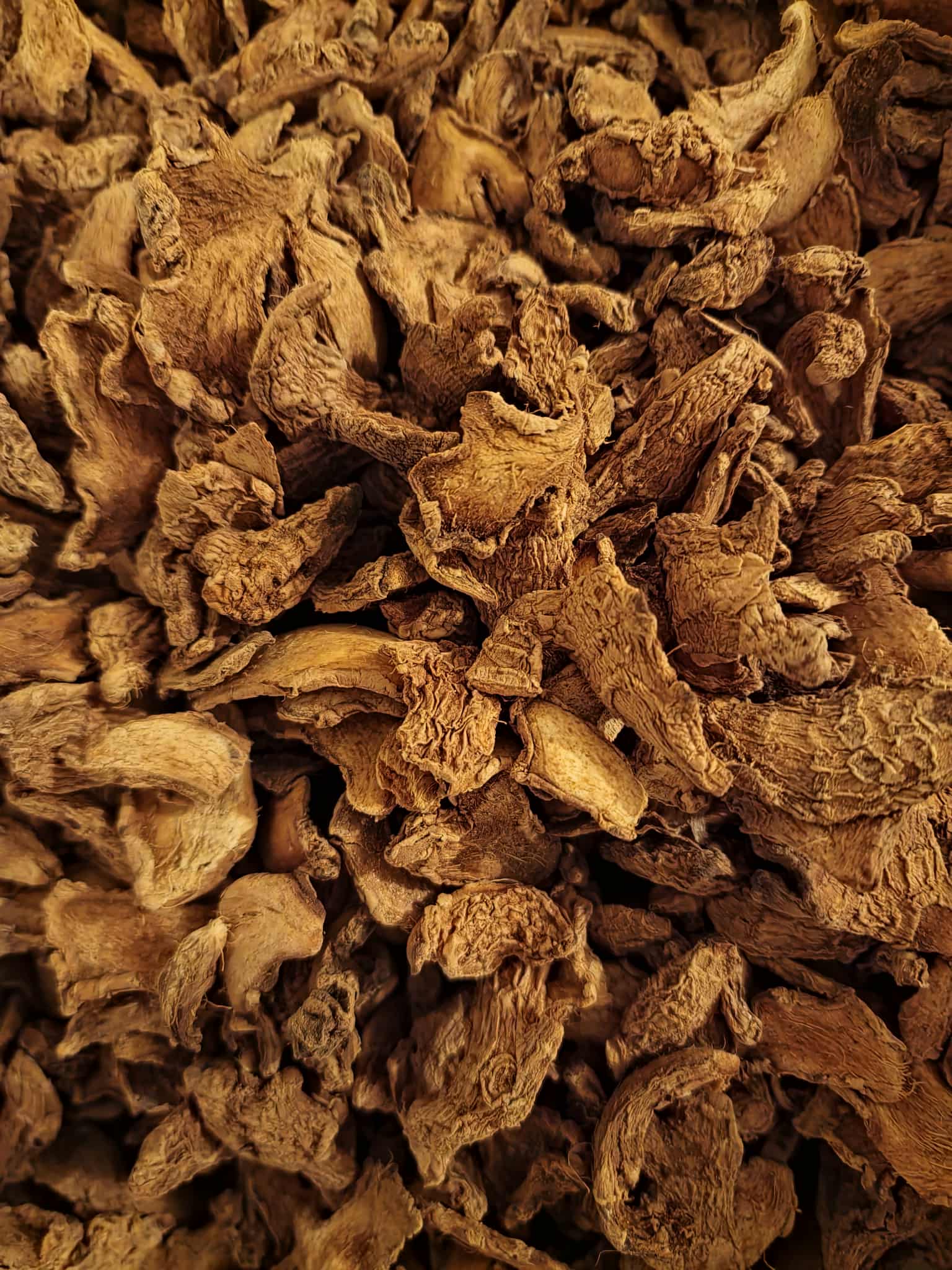 Close-up of dried Ginger root slices, an herbal remedy from Botanical Remedies herbal dispensary, loose herbal tea