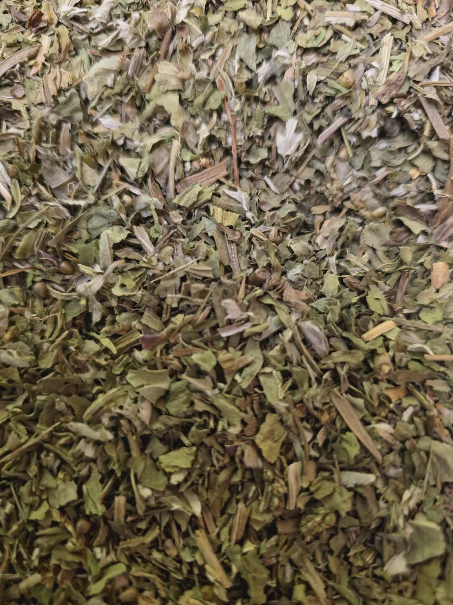 Close-up of dried and cut Organic Greater Plantain leaves, an herbal remedy from Botanical Remedies herbal dispensary, loose herbal tea