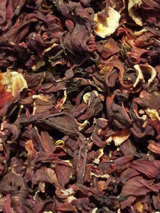 Certified Organic whole dried Hibiscus calyces (Hibiscus sabdariffa) displaying deep pink-red and purple floral pieces for ruby herbal tea infusions.