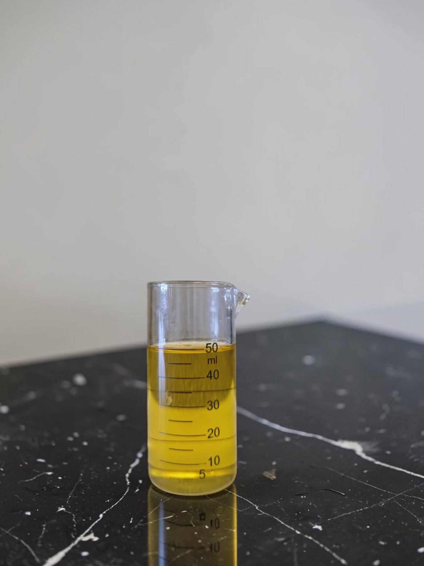 Glass measuring cup with 100% pure Organic Primrose golden oil