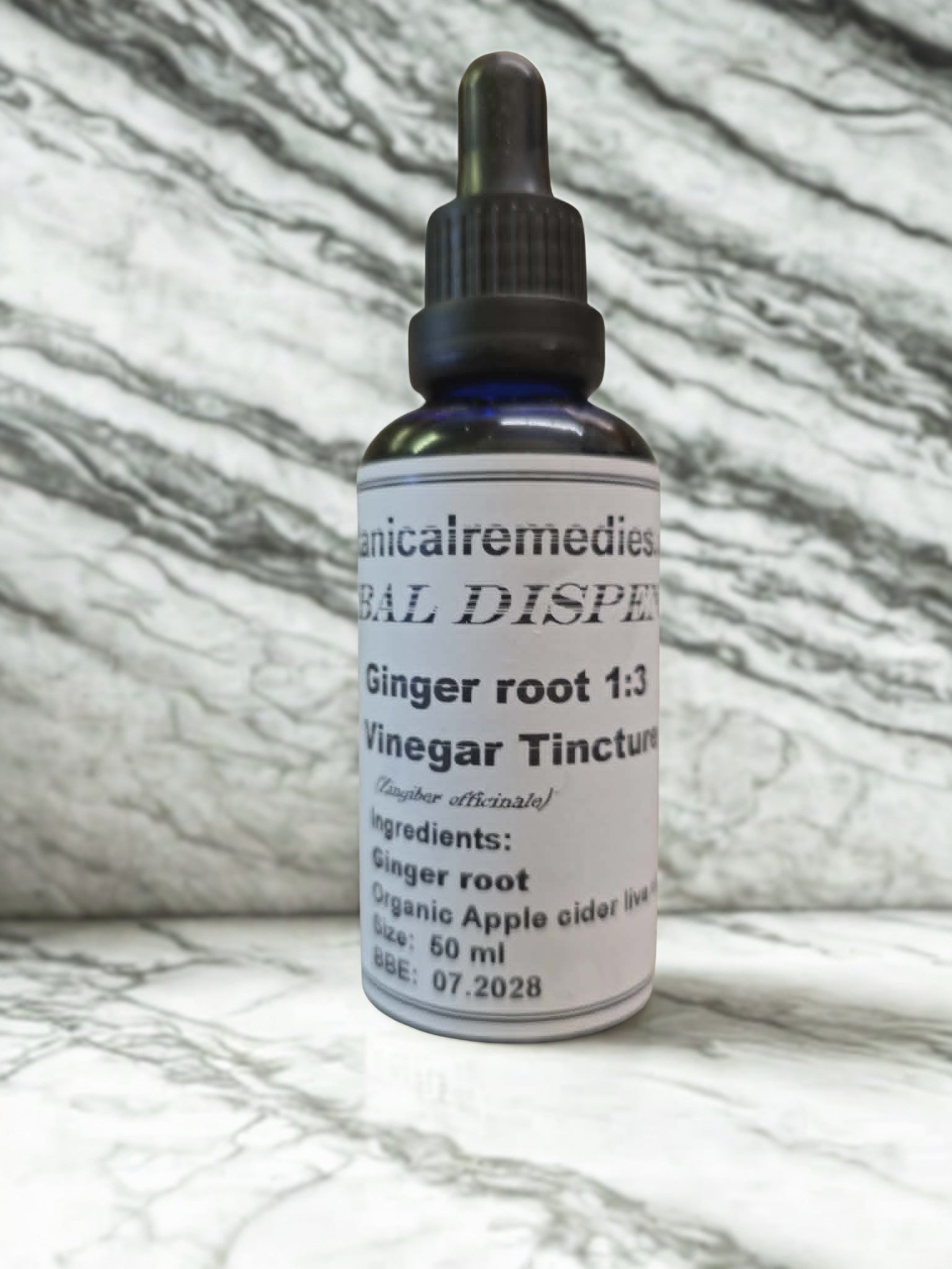Ginger Root Vinegar Tincture (Zingiber officinale) by Botanical Remedies. A practitioner-grade 50ml blue glass dropper bottle highlighting its 1:3 extraction ratio and live organic apple cider vinegar base, beautifully presented on a natural marble apothecary counter