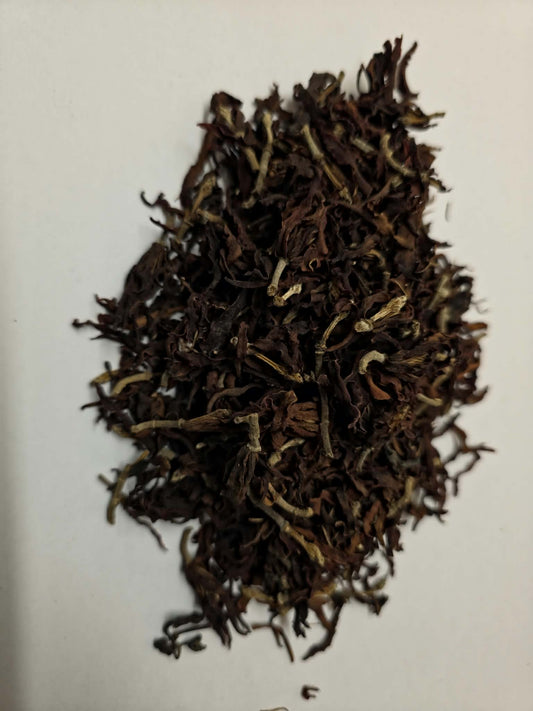 Whole dried Magnolia flowers (Magnolia grandiflora) showing intact dark mahogany blossoms and stems for aromatic tea infusions and nasal steams.