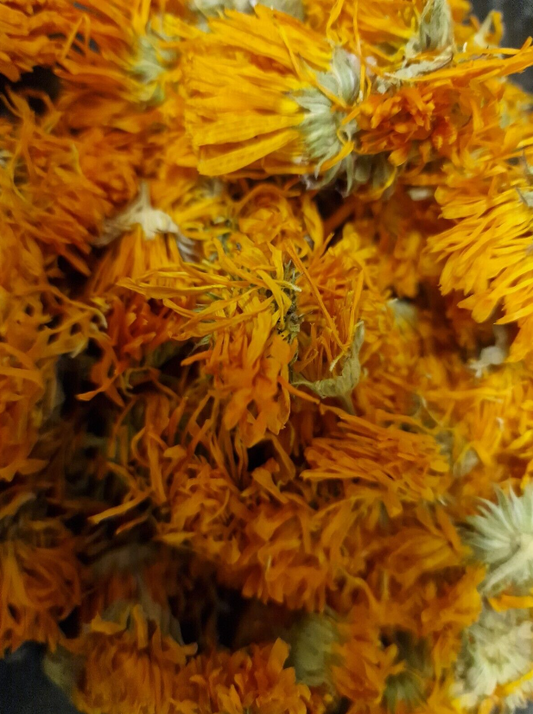 close up of orange marigold flowers dried, an loose herbal tea