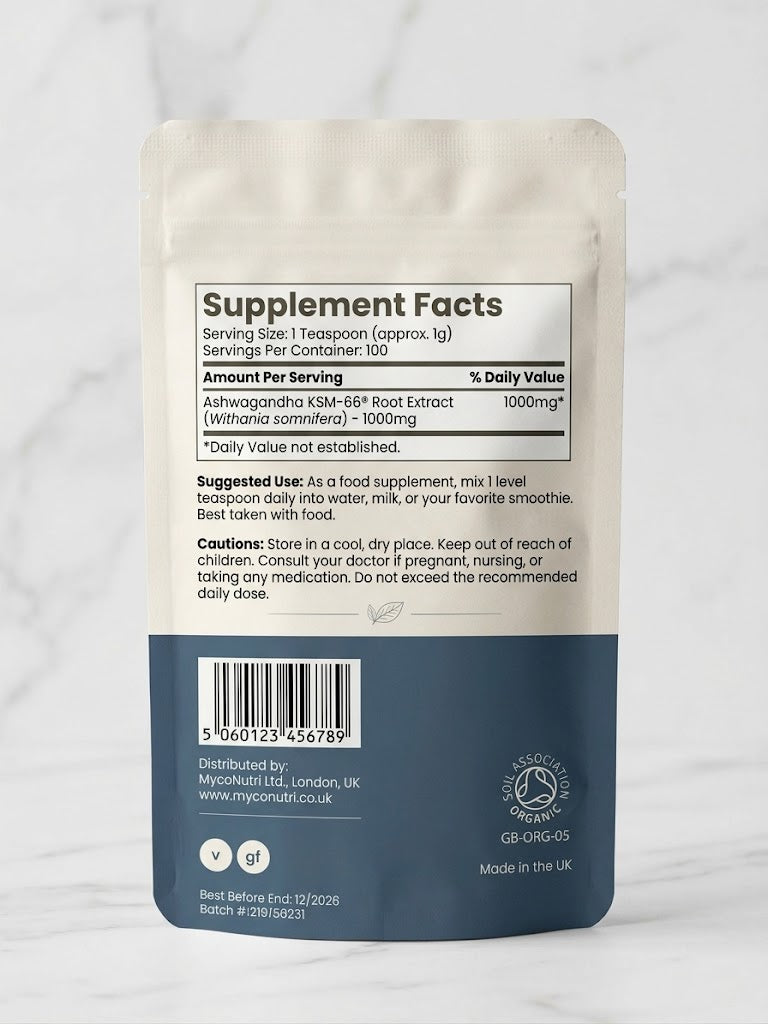 Back of MycoNutri Organic Ashwagandha KSM-66 powder pouch displaying the >5% withanolide standardization and Soil Association certification on a white marble surface.