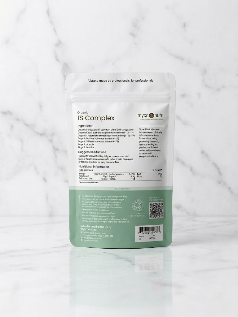 Back of MycoNutri Organic IS Complex powder pouch displaying the 5-mushroom clinical blend, nutritional information, and Soil Association certification on a white marble surface.