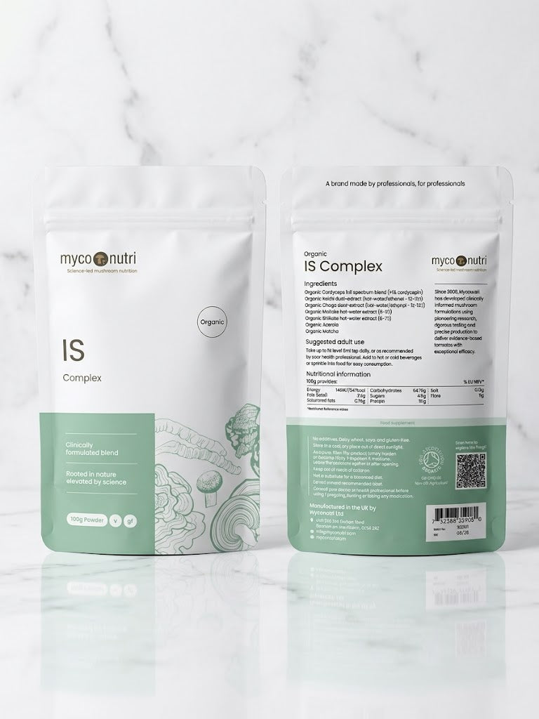 Front and back view of the MycoNutri Organic IS Complex 100g powder pouch, displaying the 5-mushroom clinical formulation, ingredients, and Soil Association organic certification on a minimalist white marble table.