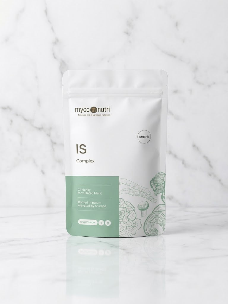 Front of MycoNutri Organic IS Complex 100g powder pouch resting on a minimalist white marble table