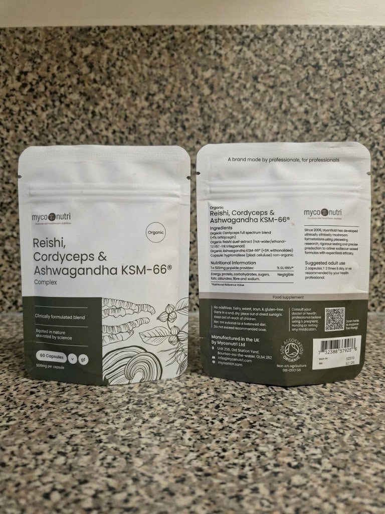 Front and back view of the MycoNutri Organic Reishi, Cordyceps & Ashwagandha KSM-66 Complex pouches resting on a granite surface, displaying 60 vegan capsules and organic certification details.