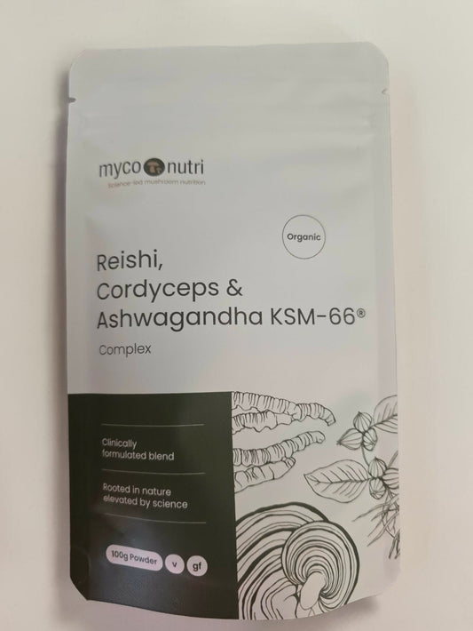 Front view of the clean white and dark green MycoNutri Organic Reishi, Cordyceps & Ashwagandha KSM-66 Complex 100g powder pouch. The minimalist label features elegant botanical illustrations of all three adaptogens and highlights it as a clinically formulated, vegan, and gluten-free blend
