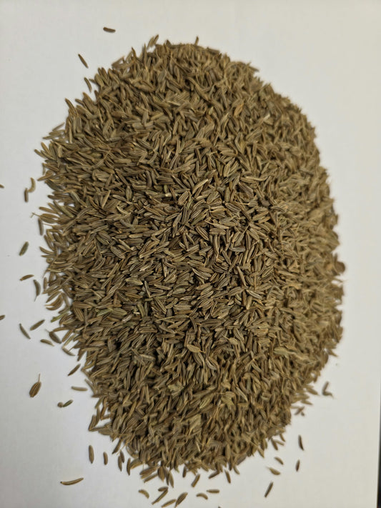 Pile of Soil Association Certified Organic whole caraway seeds (Carum carvi) for warming digestive herbal tea infusions.