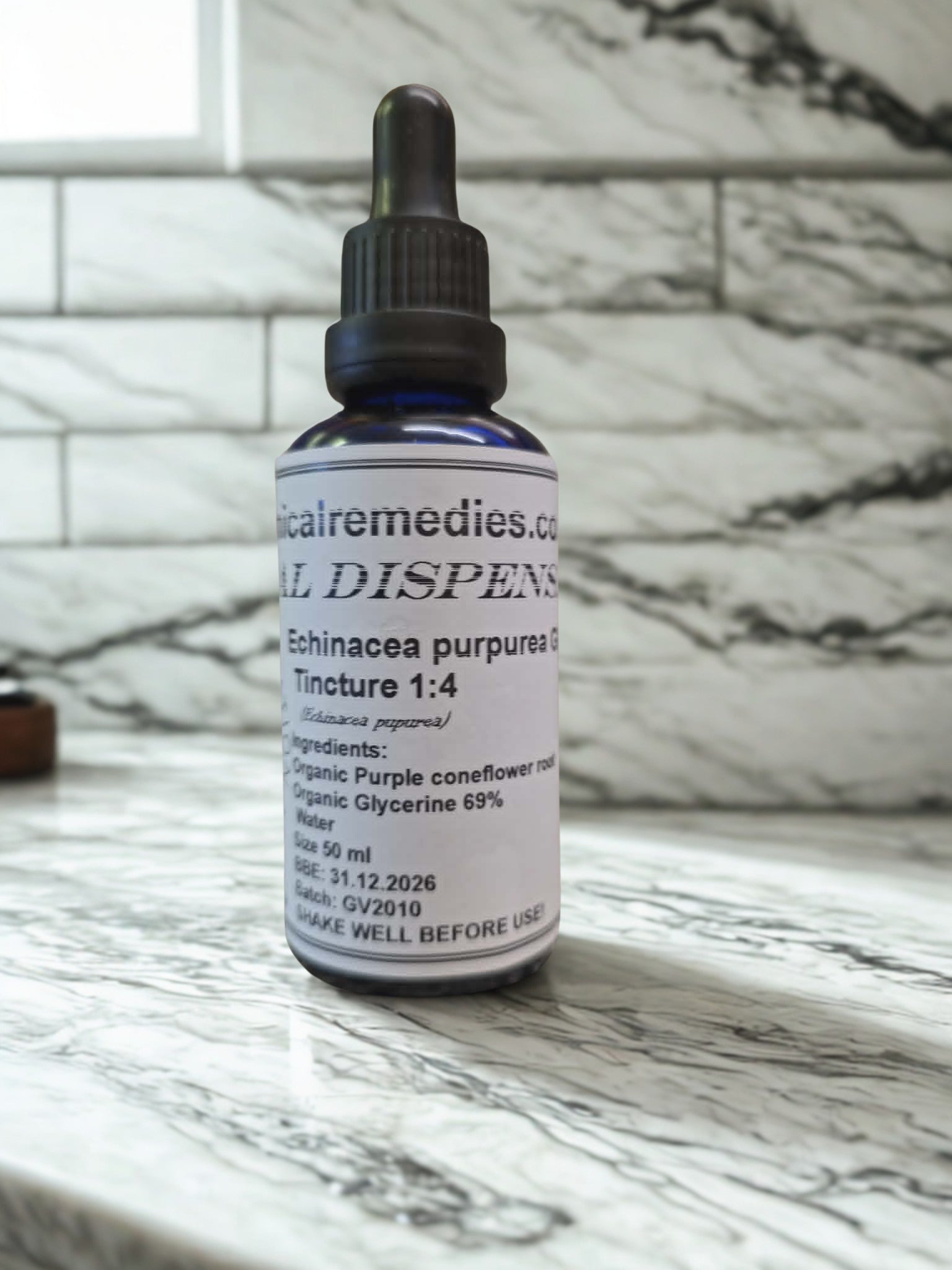 A 50ml blue glass dropper bottle of Botanical Remedies Organic Echinacea purpurea Root Glycerite (1:4) resting on a white marble countertop