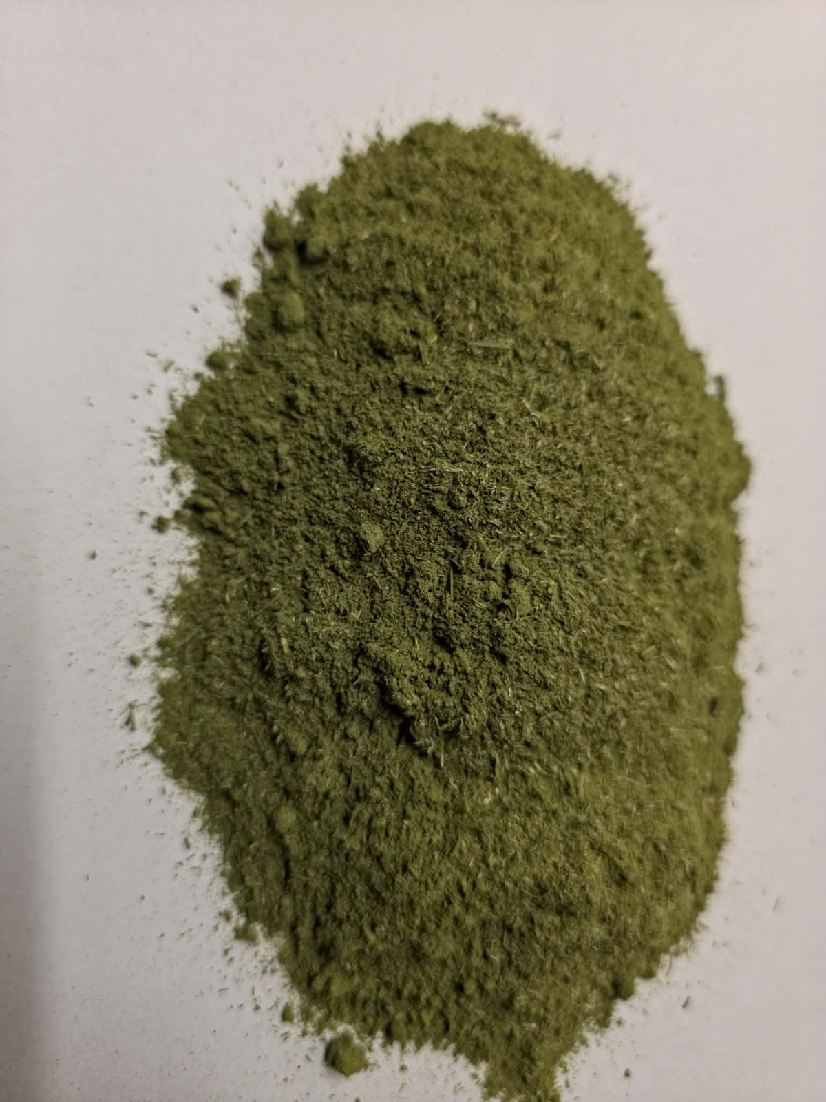 Finely milled pale green Organic Horsetail herb powder (Equisetum arvense) on a clean white background for botanical encapsulation, dietary integration, and traditional infusions.