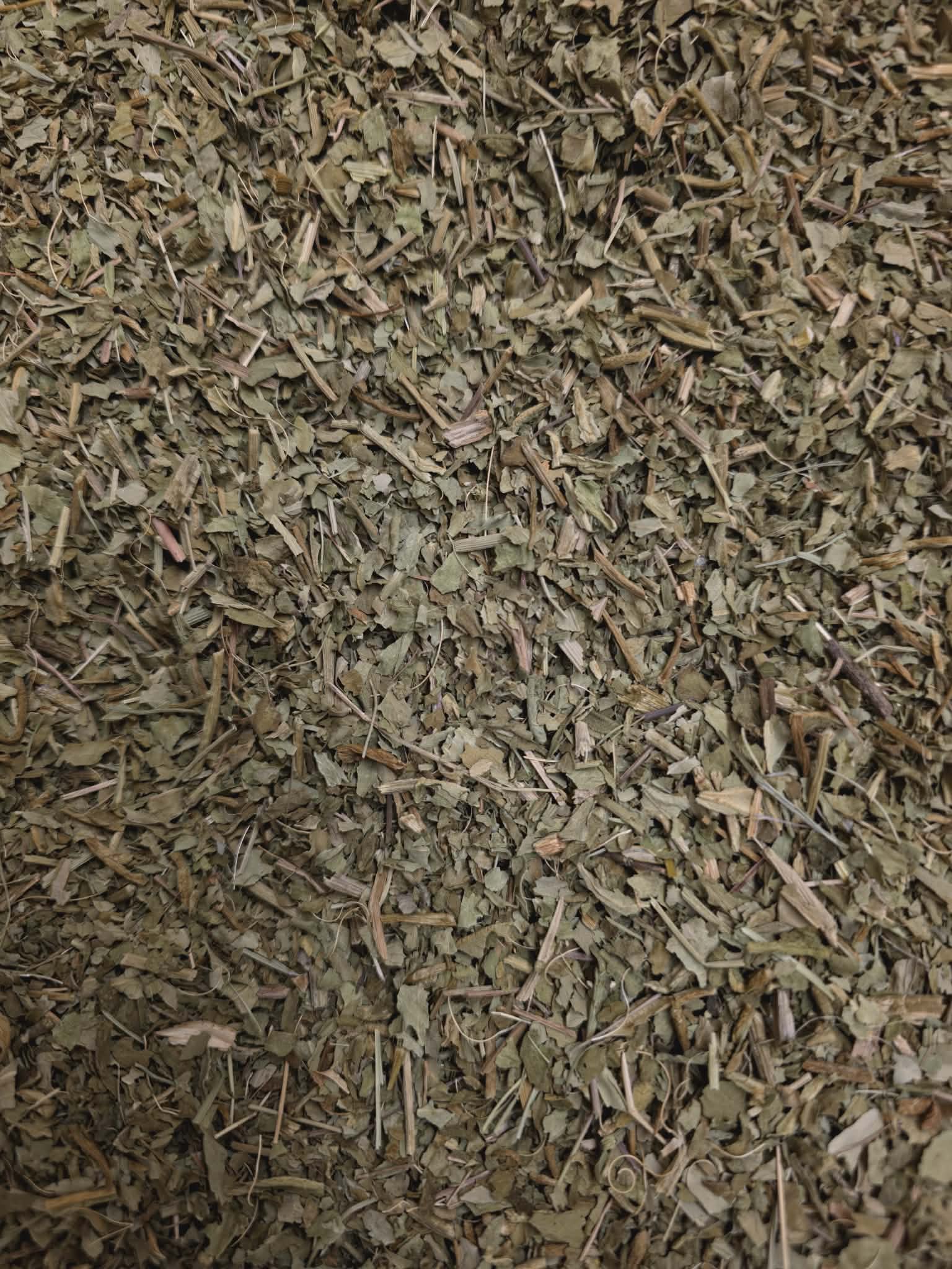 Close-up of premium dried and chopped organic Menyanthes trifoliata (Buckbean) leaf, featuring a finely cut blend of dark green botanical fragments and light, fibrous stems.