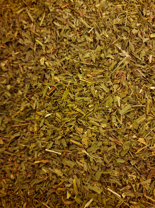 Pure dried cut Tarragon leaves (Artemisia dracunculus) showing clean olive-green leaf cut for herbal tea infusions and culinary craft.