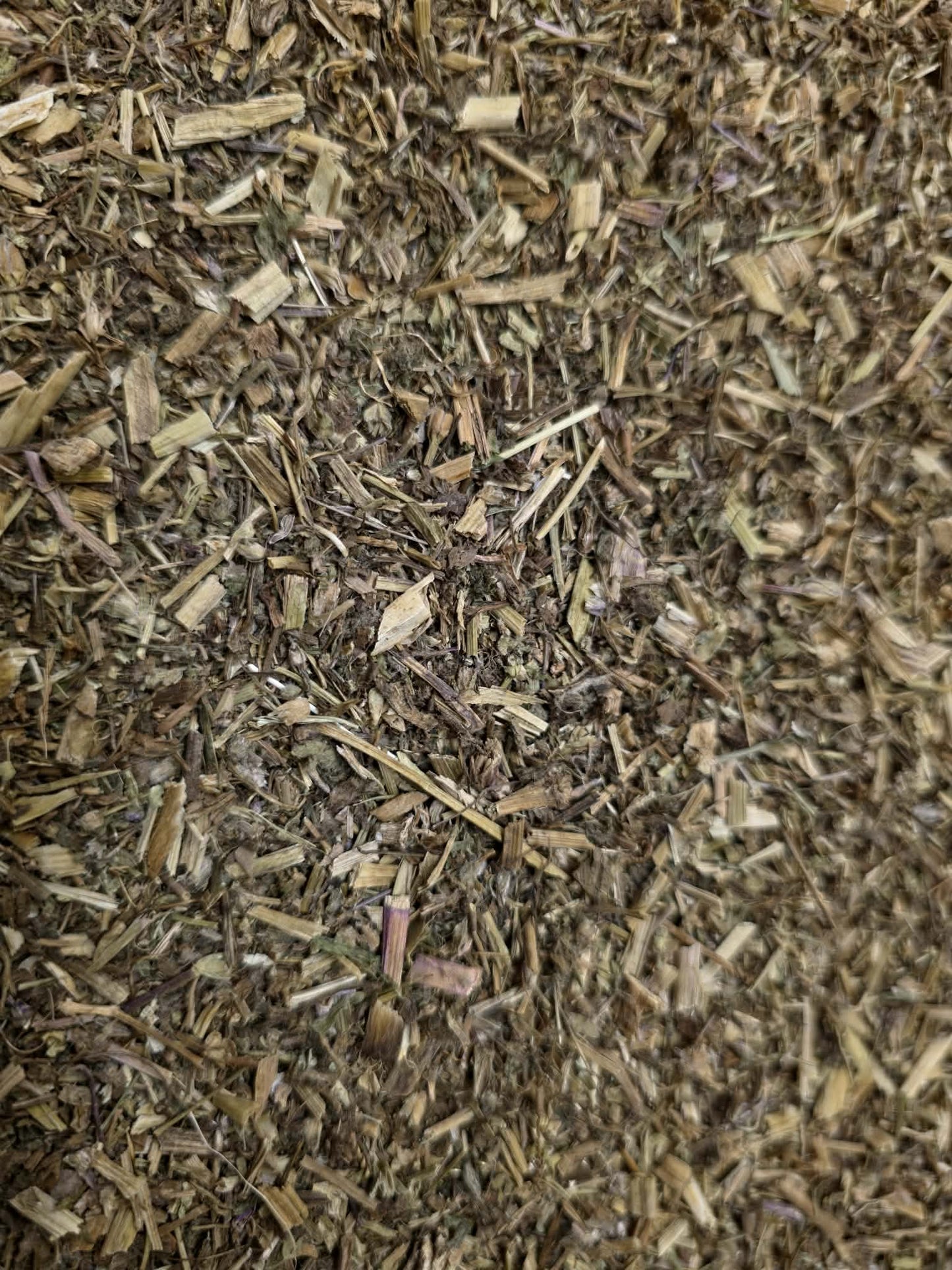Texture view of wild-grown Hungarian Crane's-bill herb (Geranium robertianum / Herb Robert) dried cut aerial leaves and stems.